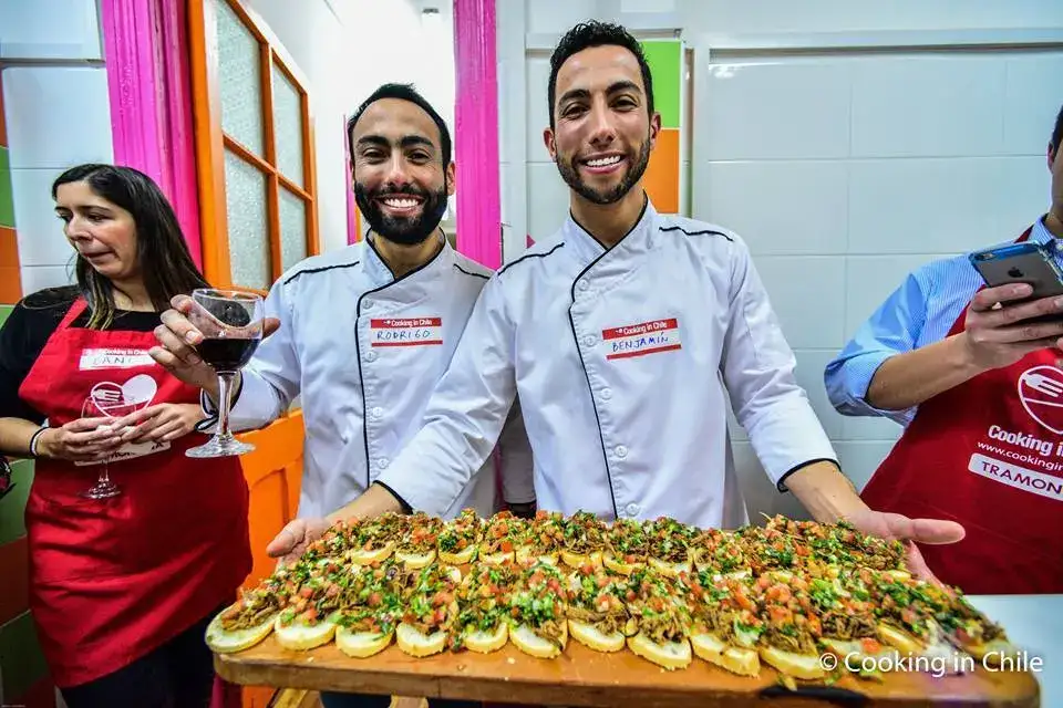 Chefs presentando una tabla de canapés